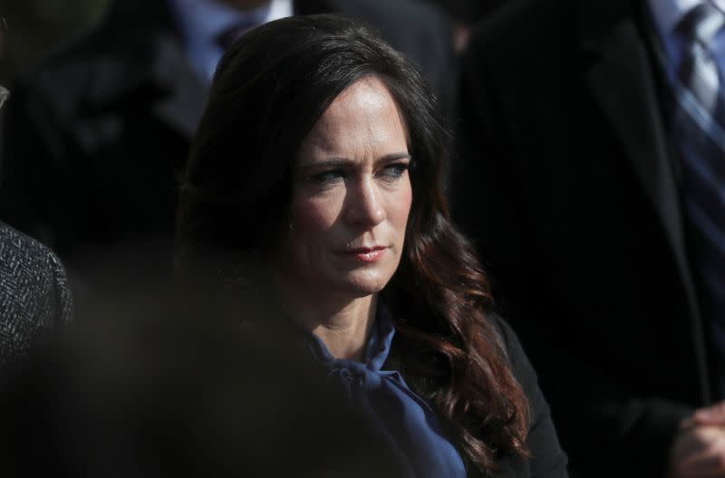 FILE PHOTO: Press Secretary Stephanie Grisham listens to U.S. President Trump as he departs for travel to Georgia at the White House in Washington