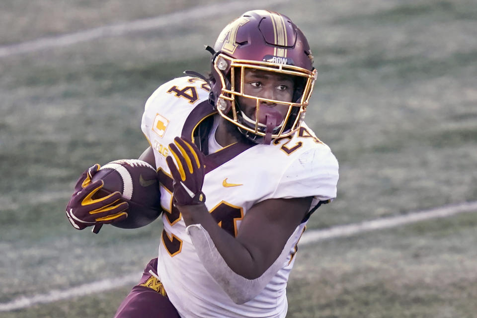 FILE - Minnesota running back Mohamed Ibrahim carries the ball during the first half of an NCAA college football game against Illinois in Champaign, Ill., in this Saturday, Nov. 7, 2020, file photo. There will be no easing into the season for most Big Ten teams. Ibrahim said he and his teammates are juiced up playing the team that's won four straight Big Ten titles and played in the national championship game in January. (AP Photo/Charles Rex Arbogast, File)