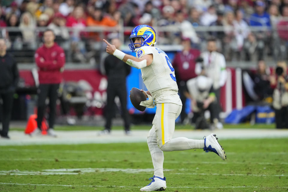 Los Angeles Rams quarterback Matthew Stafford gestures as he scrambles during the second half of an NFL football game against the Arizona Cardinals, Sunday, Nov. 26, 2023, in Glendale, Ariz. (AP Photo/Matt York)