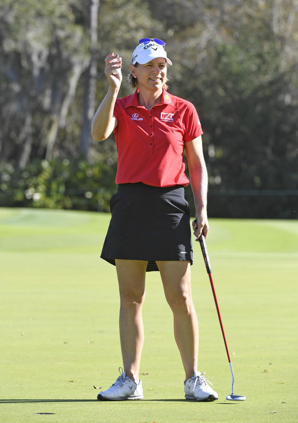 Annika Sorenstam of Sweden dressed in red and black waves to fans on the putting green during the final round of the Gainbridge LPGA golf tournament Sunday, Feb. 28, 2021, in Orlando, Fla. (AP Photo/Stan Badz)