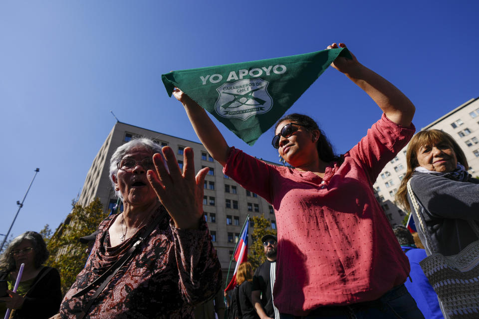 People take part in a demonstration seeking justice for police officers killed in the line of duty, in front of the La Moneda presidential palace in Santiago, Chile, Saturday, April 27, 2024. Three police officers were killed early Saturday, in Cañete, Chile's Bío Bío region. (AP Photo/Esteban Felix)