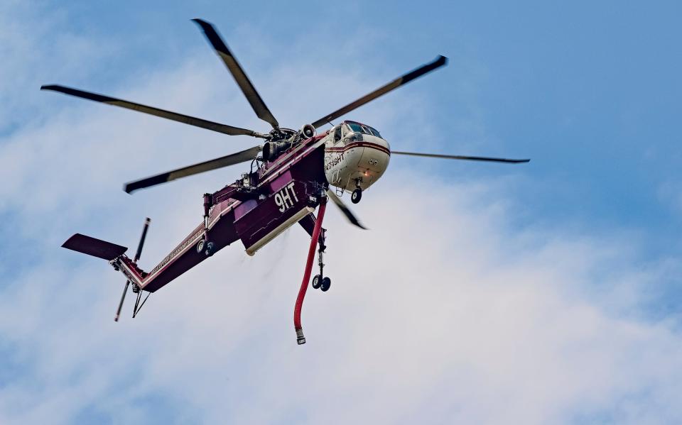 A helicopter works at the Wishon Fire on Wednesday, August 17, 2022 along Highway 190 near The Stairs picnic area. 