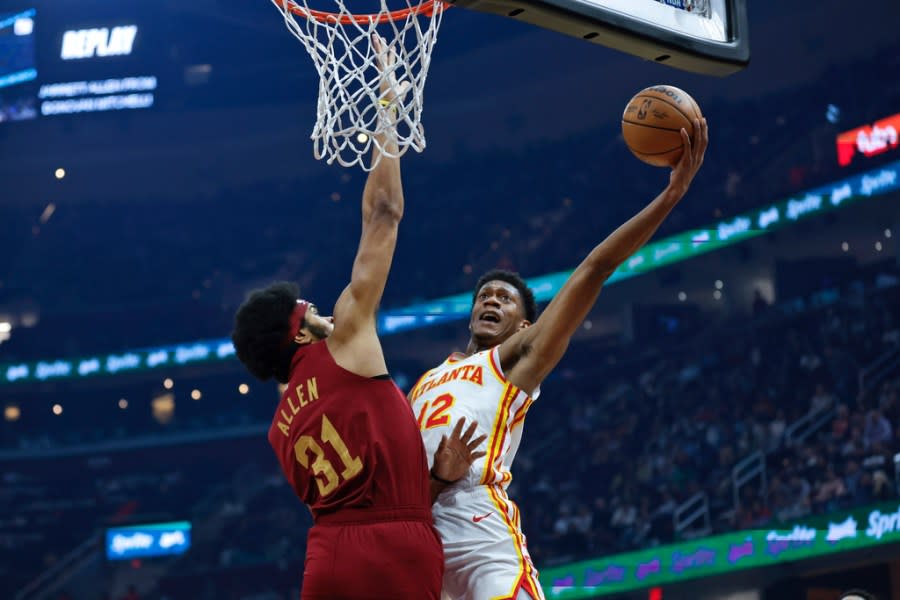 Atlanta Hawks forward De’Andre Hunter (12) shoots against Cleveland Cavaliers center Jarrett Allen (31) during the first half of an NBA basketball game Saturday, Dec. 16, 2023, in Cleveland. (AP Photo/Ron Schwane)