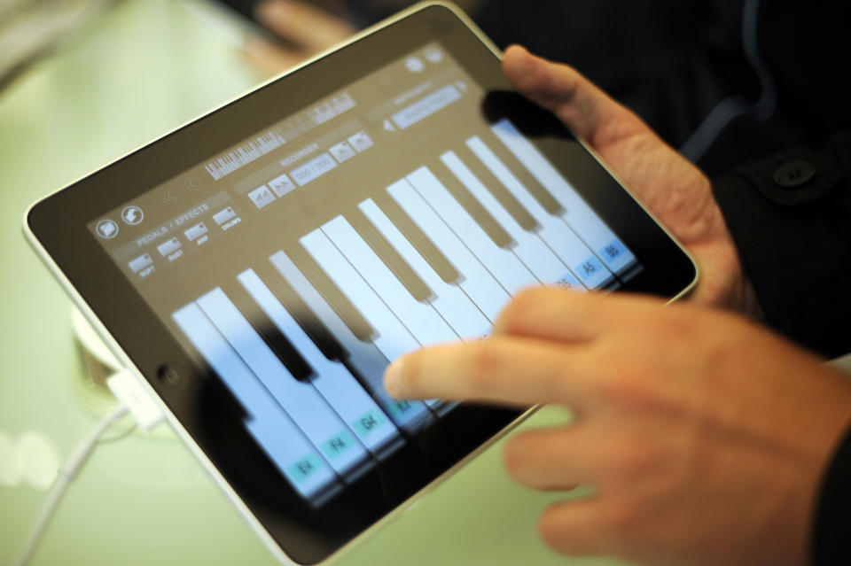 A customer tries out Apple's new iPad with a software featuring a keyboard as it is launched in a shop in Berlin on May 28, 2010. The iPad -- a flat, 10-inch (25-centimetre) black tablet targeted at the leisure market -- was going on sale in Japan, Australia, Britain, Canada, France, Germany, Italy, Spain and Switzerland as part of a staggered global roll-out.     AFP PHOTO    BARBARA SAX (Photo credit should read BARBARA SAX/AFP via Getty Images)