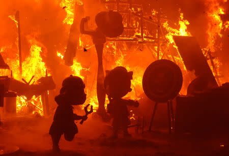 Figures that are part of a Fallas monument burn during the finale of the Fallas festival, which welcomes Spring and commemorates Saint Joseph's Day, in Valencia early March 20, 2019. REUTERS/Heino Kalis