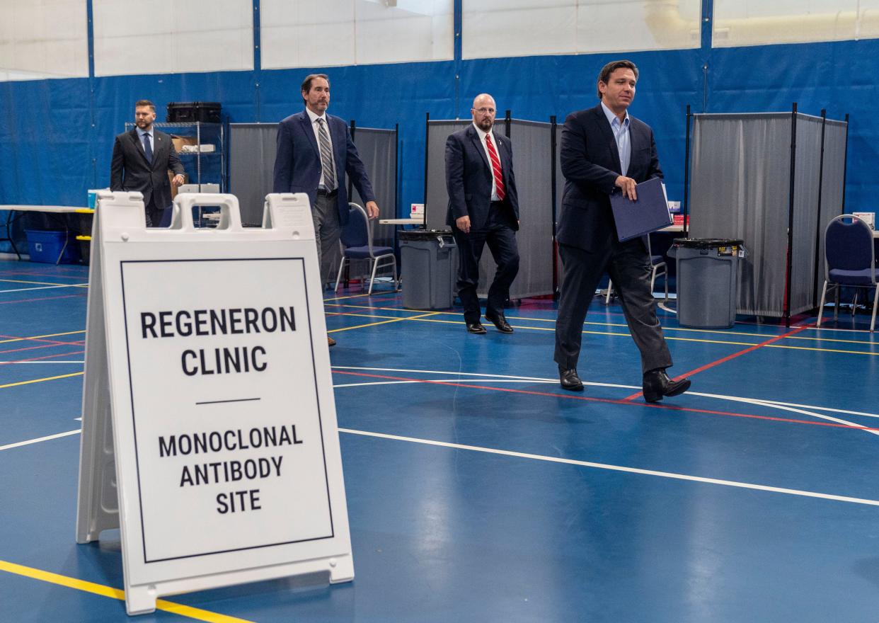 Governor Ron DeSantis, walks with FDEM Director Kevin Guthrie, left, FDEM Chief Medical Officer Dr. Kenneth Scheppke and state senator John Snyder during a visit to a new monoclonal antibody treatment site in Westgate Park in West Palm Beach, Florida on August 18, 2021.