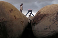 <p>Children play on pontoons as clouds gather over the banks of the river Ganges in Allahabad, India on Aug. 30, 2016. 9REUTERS/Jitendra Prakash0 </p>