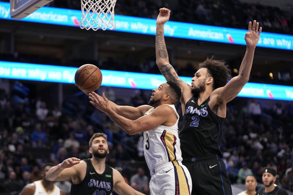 New Orleans Pelicans guard CJ McCollum (3) takes a shot as Dallas Mavericks' Maxi Kleber, left, and Dereck Lively II (2) defend in the first half of an NBA basketball game in Dallas, Monday, Jan. 15, 2024. (AP Photo/Tony Gutierrez)