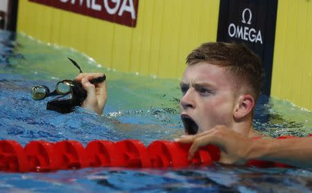 Swimming – 17th FINA World Aquatics Championships – Men's 50m Breaststroke Preliminary – Budapest, Hungary – July 25, 2017 – Adam Peaty of Britain reacts after he comes first. REUTERS/Stefan Wermuth