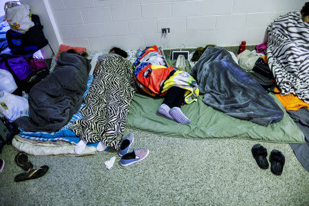 People are seen inside a shelter run by Red Cross before Hurricane Florence comes ashore in Grantsboro, North Carolina, U.S., September 13, 2018. REUTERS/Eduardo Munoz