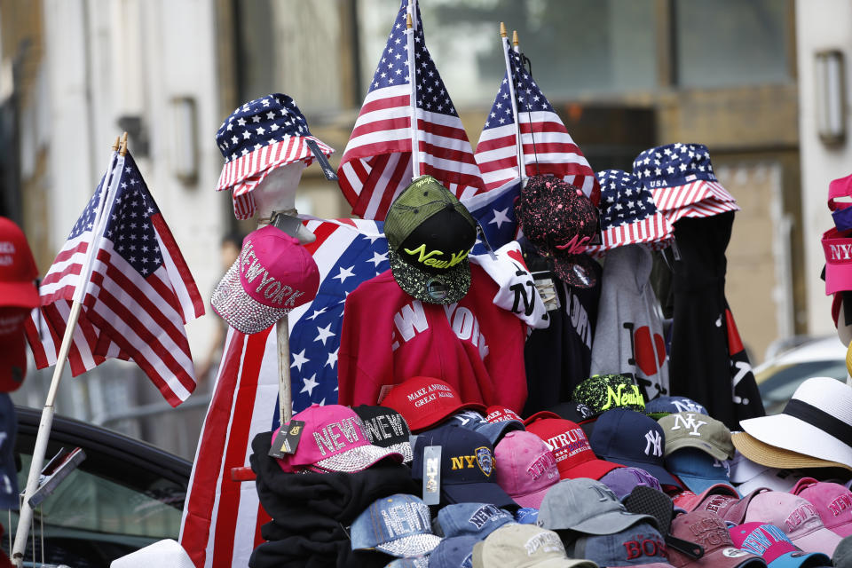 Flag-themed souvenirs are for sale along Broadway, also known as the "Canyon of Champions," along the parade route in lower Manhattan, one day ahead of a ticker-tape parade and City Hall ceremony for the four-time World Cup winning U.S. women's soccer team, Tuesday, July 9, 2019, in New York. (AP Photo/Kathy Willens)