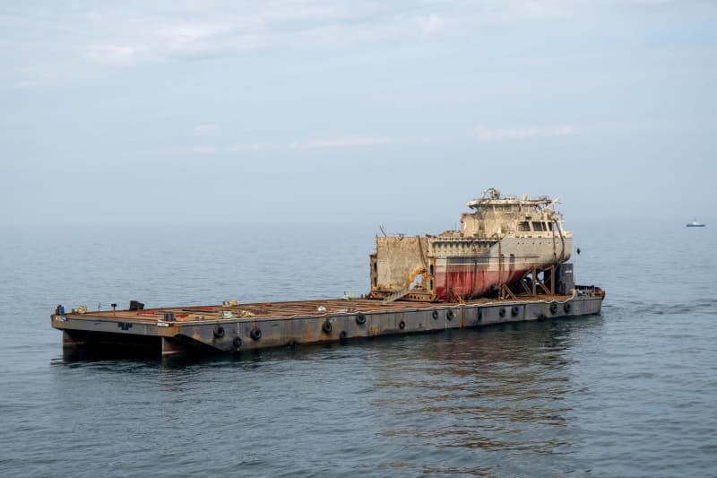 The recovered stern of the sunken freighter "Truth"which is split in two, lies on a platform. On October 24, 2023, the "Truth" and the cargo ship "Poland" collided southwest of Heligoland and "Truth" had sunk. The salvage of the sunken "Truth" has now been postponed. Sina Schuldt/dpa