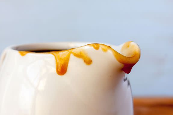 Close-up of the spout of a gravy boat with gravy dripping down; Shutterstock ID 433787635