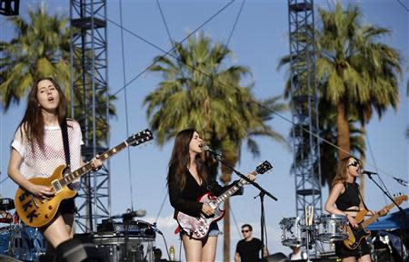Danielle Haim (C) and her sisters Alana Haim (L) and Este Haim of rock band Haim perform at the Coachella Music Festival in Indio, California April 11, 2014. A slew of rising artists and bands kicked off the annual Coachella Valley Music and Arts Festival on Friday, ahead of the much anticipated reunion of hip-hop duo Outkast headlining the first night of the three-day festival. REUTERS/Mario Anzuoni