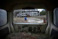 A boy runs through the site of Beichuan Vocational Education Centre which was destroyed in the 2008 Sichuan earthquake in the city of Beichuan, Sichuan province, China, April 6, 2018. REUTERS/Jason Lee