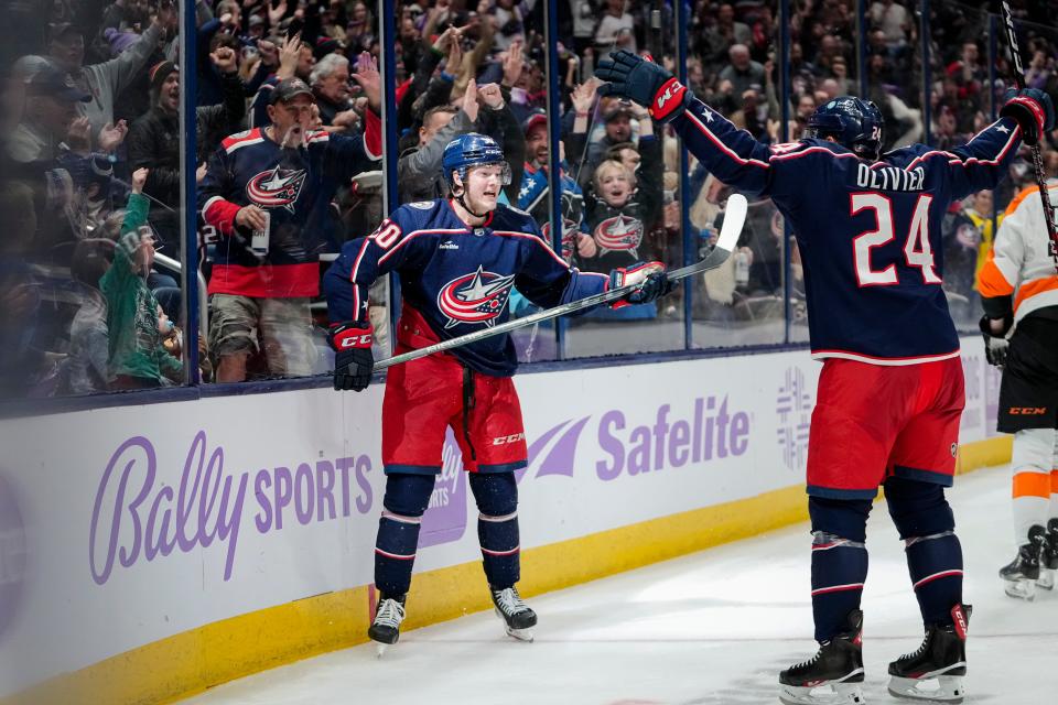 Nov 15, 2022; Columbus, Ohio, USA;  Columbus Blue Jackets left wing Eric Robinson (50) celebrates scoring a goal with right wing Mathieu Olivier (24) during the third period of the NHL hockey game against the Philadelphia Flyers at Nationwide Arena. The Blue Jackets won 5-4. Mandatory Credit: Adam Cairns-The Columbus Dispatch