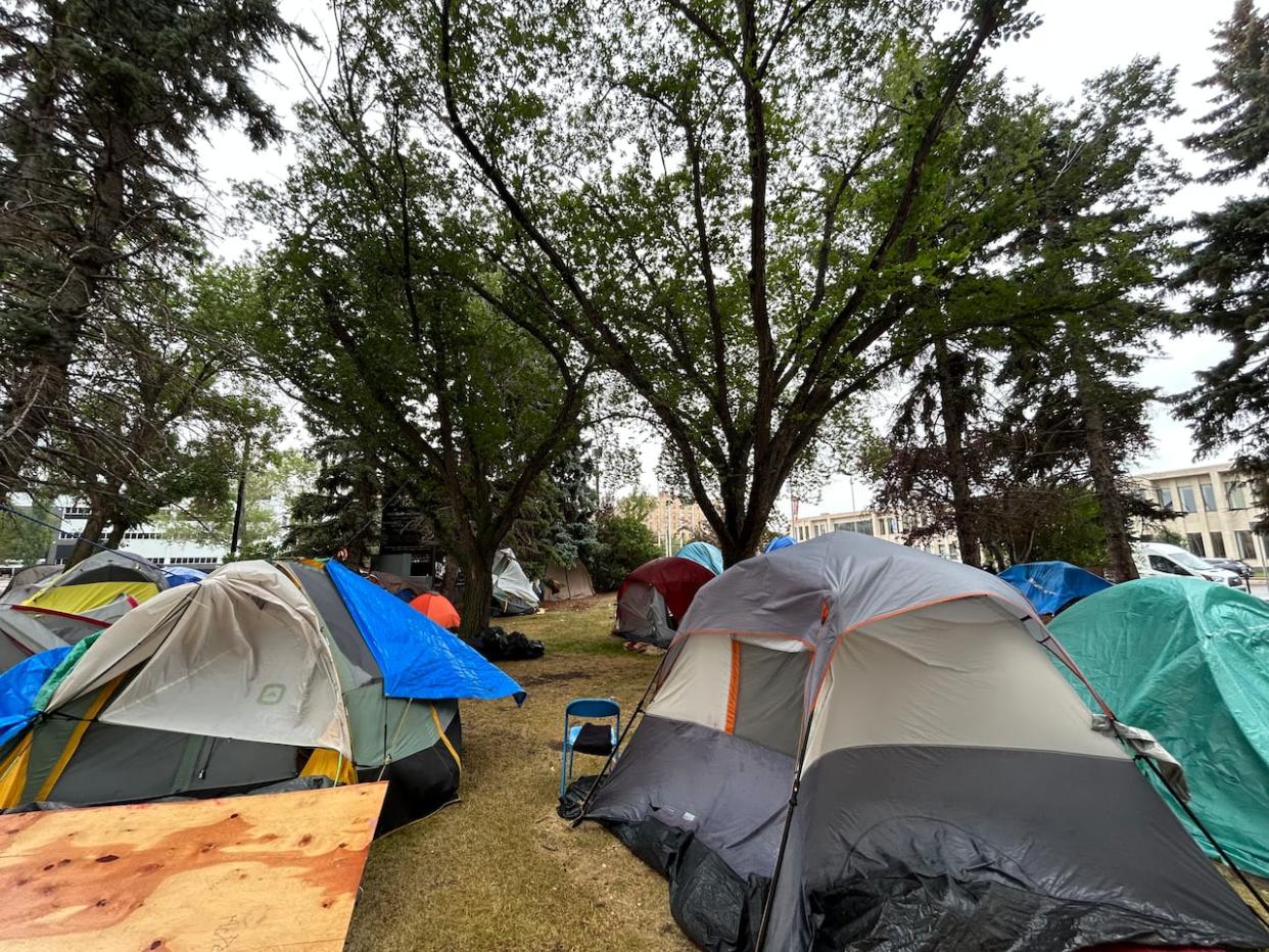 The city said in a news release Tuesday that at last count there were 83 tents on the city hall courtyard and about 45 to 60 people living there. (Laura Sciarpelletti/CBC - image credit)