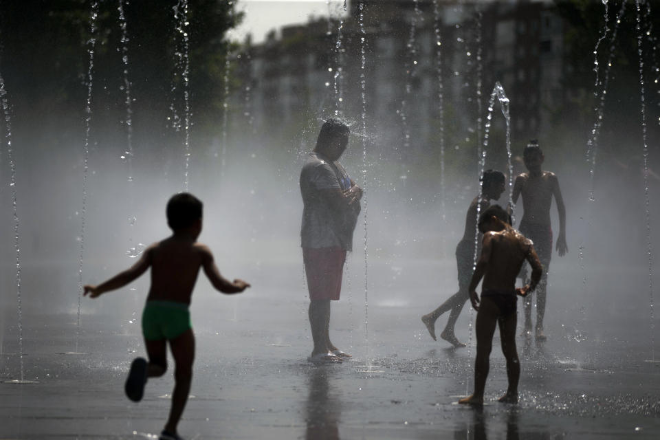 People cool off in an urban beach at Madrid Rio park in Madrid, Friday, Aug. 3, 2018. Spain's Meteorological Agency says eight provinces in the southern Andalusia region and around Madrid are under high risk because of the heat wave hitting the country starting on Wednesday. (AP Photo/Francisco Seco)