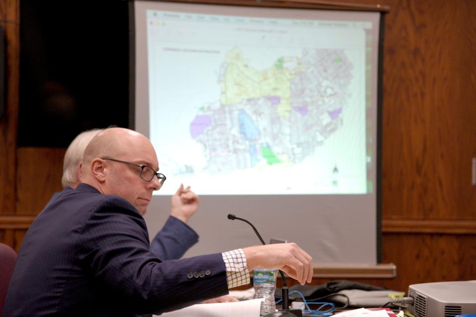 Attorney John Anderson, left, with Michael Simpson, architect and planner for Plug Naturals LLC, in front of a map of cannabis business restrictions on Thursday, January 5, 2023 at Borough Hall in Red Bank, New Jersey. 