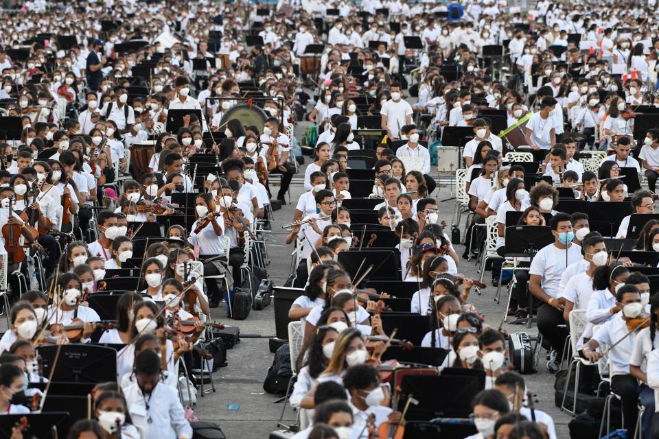 Members of the National System of Orchestras of Venezuela play during an attempt to enter the Guinness Book of Records for the largest orchestra in the world, with more than 12,000 musicians, at the Military Academy of the Bolivarian Army in Fuerte Tiuna Military Complex, in Caracas, on November 13, 2021. (Photo by Federico PARRA / AFP) (Photo by FEDERICO PARRA/AFP via Getty Images)