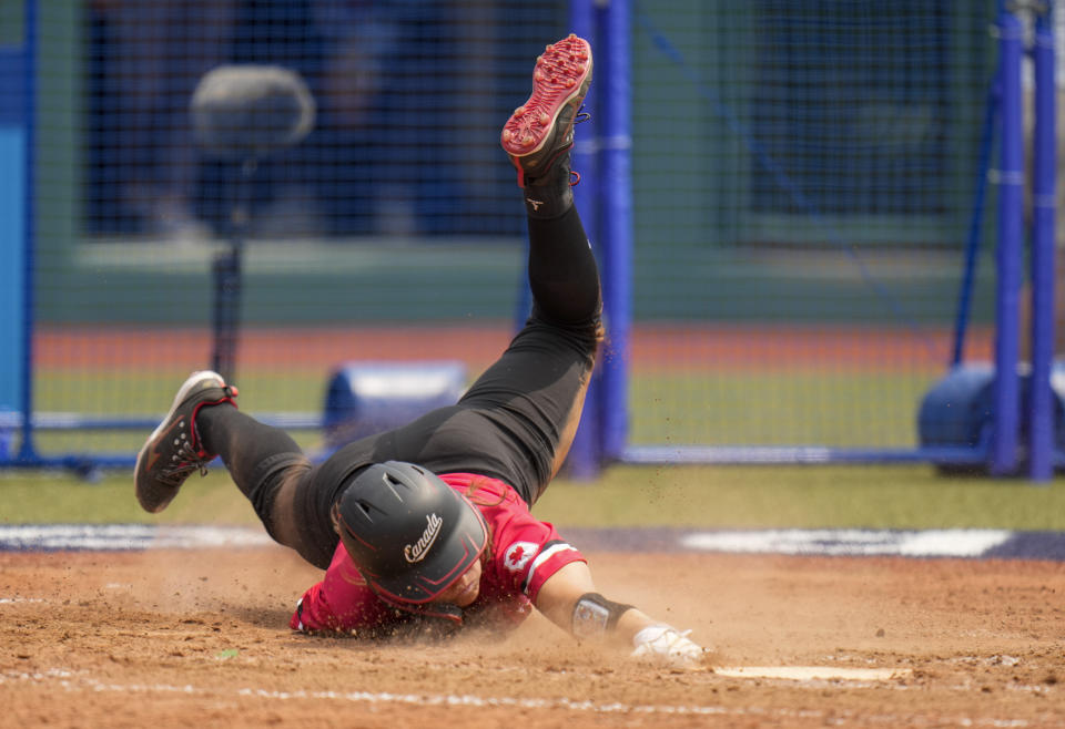 Canada's Joey Lye falls at home plate during the softball game between the United States and Canada at the 2020 Summer Olympics, Thursday, July 22, 2021, in Fukushima , Japan. (AP Photo/Jae C. Hong)