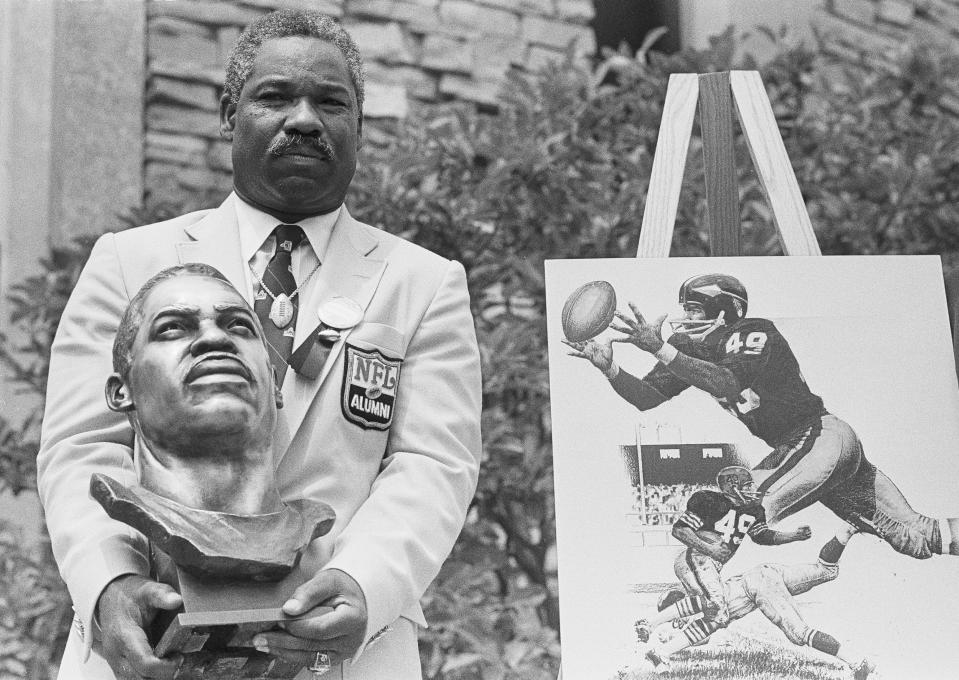  In this July 30, 1983, file photo, former Cleveland Browns and Washington Redskins halfback and wide receiver Bobby Mitchell poses with his bronze bust after being inducted into the Pro Football Hall of Fame in ceremonies in Canton, Ohio.    The Washington Redskins will retire the jersey of Mitchell and rename the lower level of FedEx Field for him, replacing former owner George Preston Marshall.  The team, which is being pressured to change its name during the ongoing national reckoning over racism, said Saturday, June 20, 2020,  that the No. 49 will become on the second in the franchise's 88-year history to be retired.   (AP Photo/Gus Chan, File)