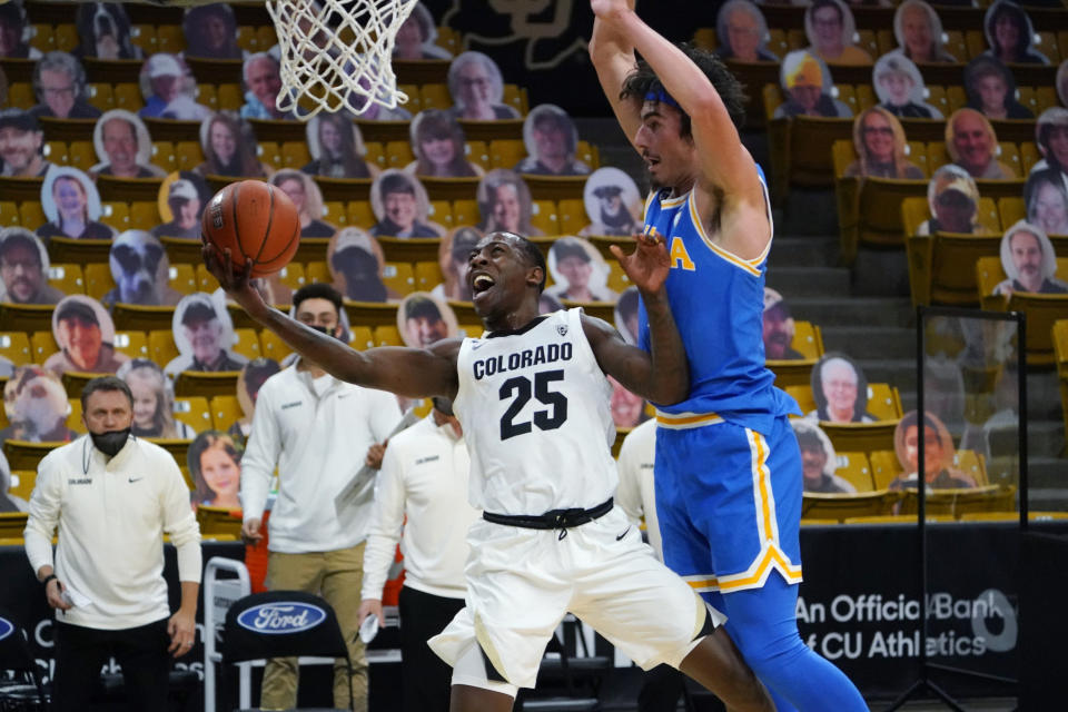 Colorado guard McKinley Wright IV looks for a shot as UCLA guard Jaime Jaquez Jr. defends during the second half of an NCAA college basketball game Saturday, Feb. 27, 2021, in Boulder, Colo. (AP Photo/David Zalubowski)