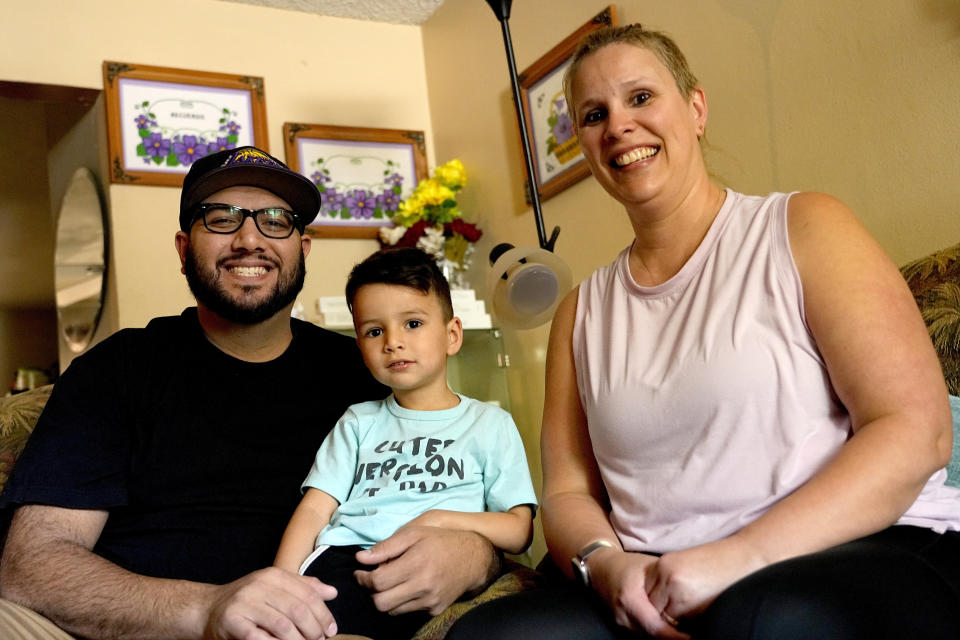 Alicia Celaya, David Cardenas and their son Adrian, 3, are shown in their home, Thursday, April 27, 2023, in Phoenix. Celaya and her family will lose their medicaid coverage later this year, a result of a year-long nationwide review of the 84 million Medicaid enrollees that will require states to remove people whose incomes are now too high for the program. Advocacy groups say beneficiaries are finding the process confusing and at times riddled with errors, leaving some of the country's poorest people suddenly without health insurance and unable to pay for necessary medical care. (AP Photo/Matt York)