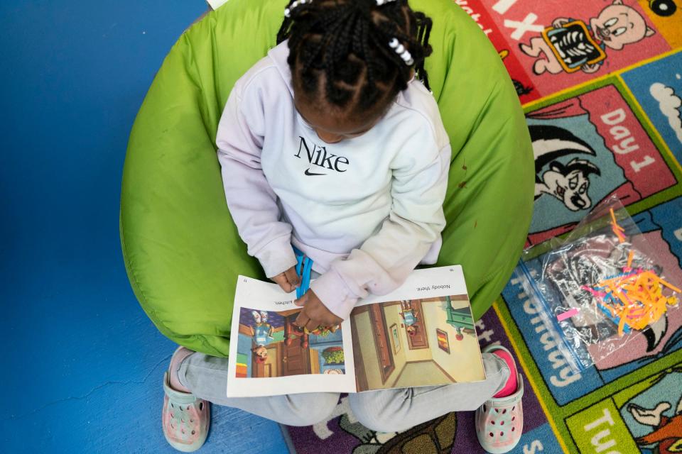 Bailee Robinson, 5, marks high-frequency words she recognizes in a book at the School of Purpose day care in Detroit on Wednesday, March 20, 2024. Tissua Franklin is the CEO of the school and is hoping to change the literacy preparation for children in Detroit. Franklin not only published a handbook to help educators and parents help their children but she has created a day care center that is focused on teaching children how to identify letters and numbers and words and to get a jump-start on reading before kindergarten.