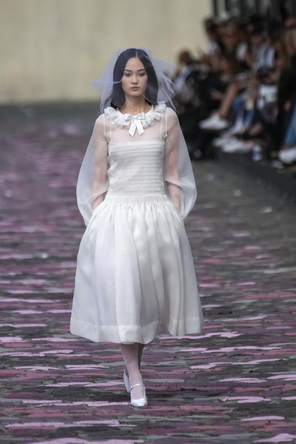 A model wears a creation for the Chanel Haute Couture Fall/Winter 2023-2024 fashion collection presented in Paris, Tuesday, July 4, 2023. (AP Photo/Christophe Ena)