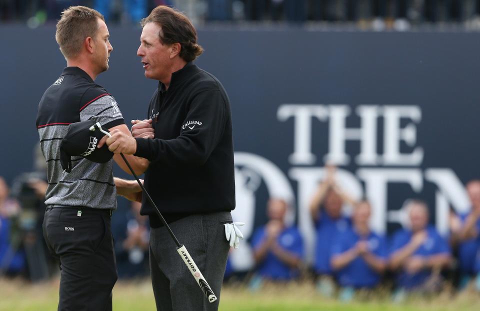 Phil Mickelson, right, congratulates Henrik Stenson after their duel in the British Open. (Reuters)