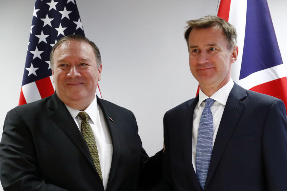 U.S. Secretary of State Mike Pompeo, left, poses with Britain's Foreign Secretary Jeremy Hunt at the European Council in Brussels, Monday, May 13, 2019. Secretary of State Mike Pompeo has changed the schedule for his latest trip to Europe, substituting a stop in Brussels for one in Moscow to discuss Iran and other issues with European officials. State Department spokesman Morgan Ortagus says Pompeo is still expected to meet Tuesday in Sochi with Russian President Vladimir Putin and Foreign Minister Sergey Lavrov. (Francois Lenoir/Pool Photo via AP)