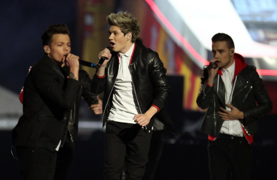 From left, Louis Tomlinson, Niall Horan and Liam Payne of British band One Direction perform on stage during the BRIT Awards 2013 at the o2 Arena in London on Wednesday, Feb. 20, 2013. (Photo by Joel Ryan/Invision/AP)