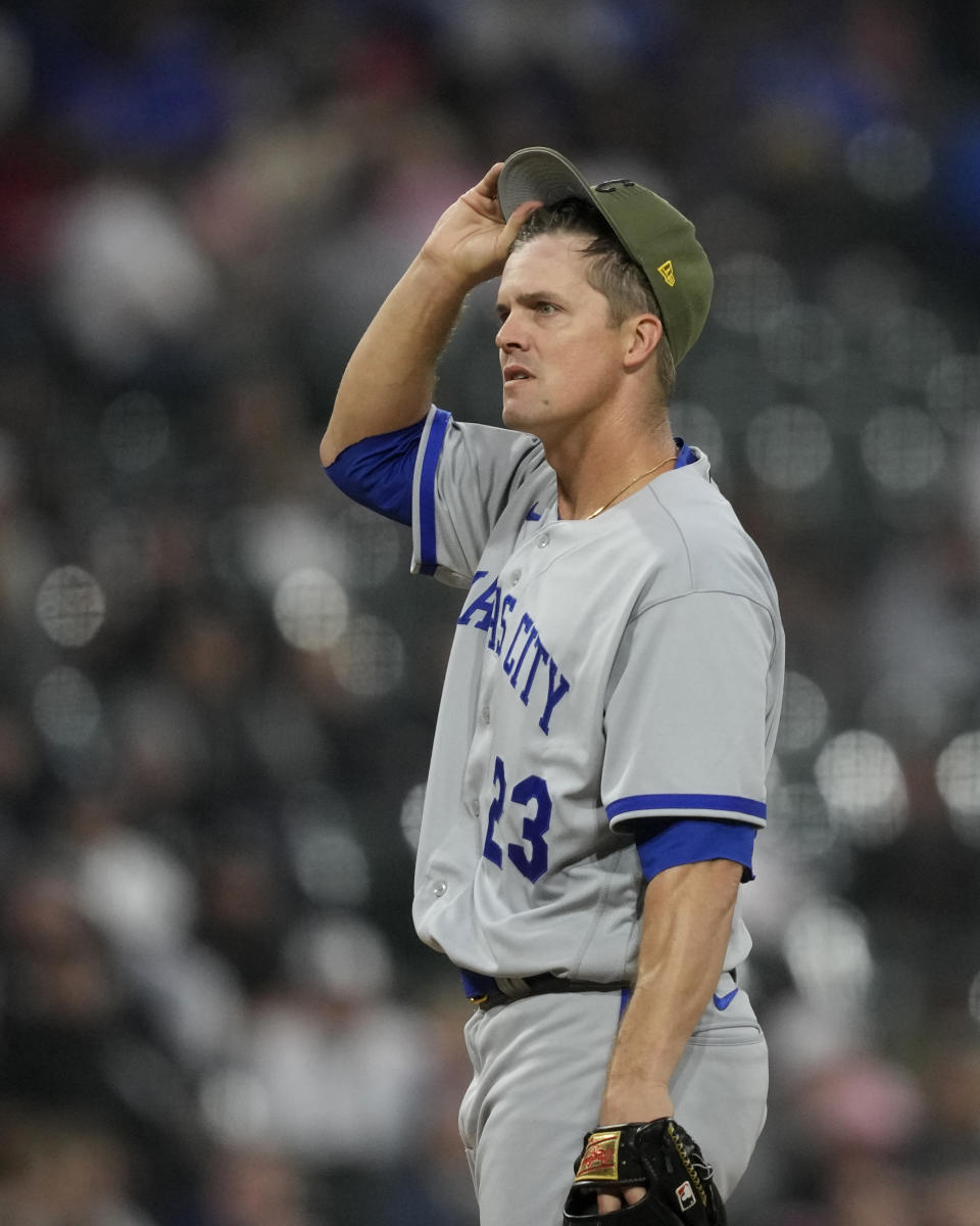Kansas City Royals starting pitcher Zack Greinke lifts his cap in the fourth inning of the team's baseball game against the Chicago White Sox on Friday, May 19, 2023, in Chicago. (AP Photo/Charles Rex Arbogast)