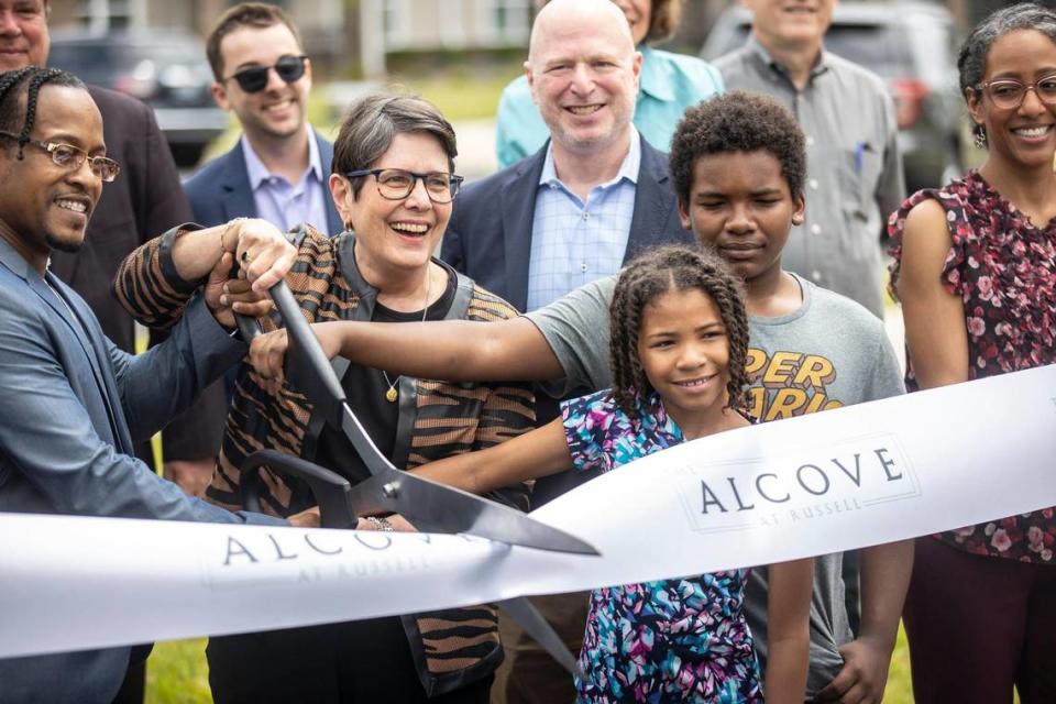 Lexington Mayor Linda Gorton, second from left, and Oliver Mabson, the complex’s property manager, left, help cut the ribbon to officially open the Alcove at Russell during a ceremony on Tuesday, June 20, 2023.