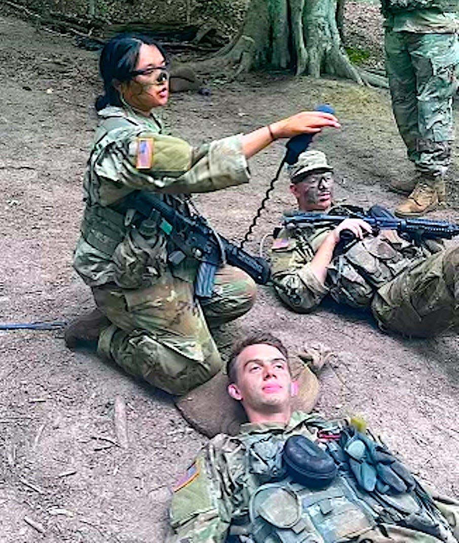 Rachel Huynh directs the triage of "casualties" while acting as platoon sergeant during an ambush exercise last summer, part of an Advance Camp held at Fort Knox, Ky.