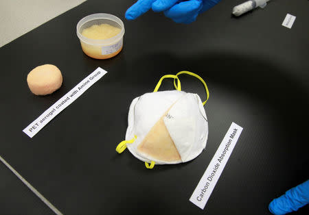 An NUS researcher explains how face masks are enhanced with Aerogel at NUS's Department of Mechanical Engineering in Singapore November 23, 2018. Picture taken November 23, 2018. REUTERS/Yiming Woo