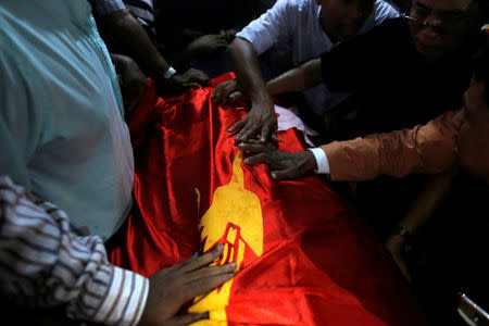 Supporters put a flag of Myanmar's ruling National League for Democracy party over the coffin of Ko Ni, a prominent member of Myanmar's Muslim minority, during his funeral in Yangon, Myanmar January 30, 2017. REUTERS/Soe Zeya Tun