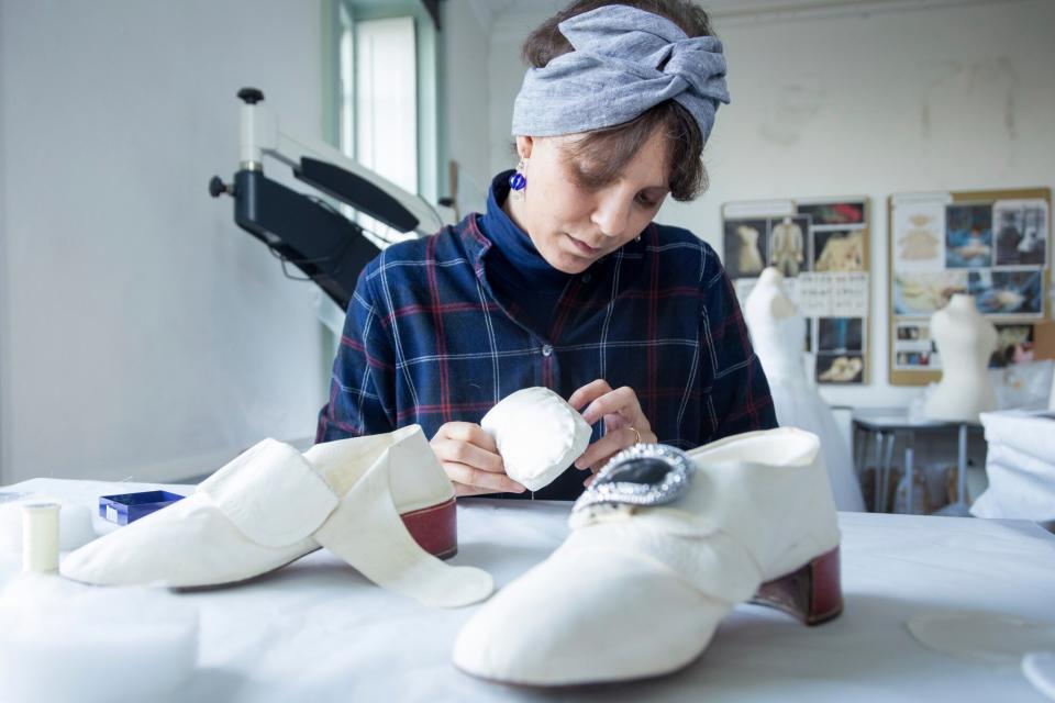 The Conservation Studio showing Viola Nicastro (Senior Textile Treatment Conservator) preparing white leather shoes, part of the Garter Robes ensemble worn by John Stuart (1761), for the Crown to Couture exhibition. Crown to Couture, a major exhibition at Kensington Palace, examines and celebrates how fashion from the royal Georgian court has inspired red-carpet catwalk designs in the 21st century. Crown to Couture 5th April – 29th October 2023.