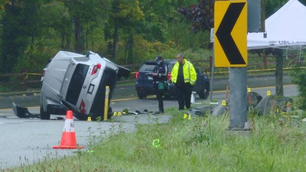 Police work at the scene of a fatal collision Sunday on Northwest Marine Drive at the University of British Columbia. (Doug Kerr/CBC News - image credit)