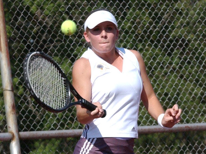 Watertown's Jenna Bakke hits a return shot during a high school girls tennis dual in August of 2002 at Highland Park.