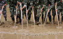 <p>Paramilitary policemen sweep a flooded street in Guilin, Guangxi province, China, July 3, 2017. (Photo: Stringer/Reuters) </p>