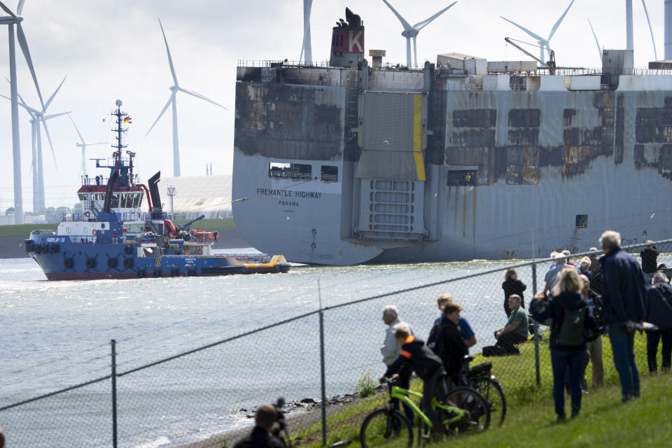 Stricken cargo ship Fremantle Highway, that caught fire while transporting thousands of cars, including nearly 500 electric vehicles, from Germany to Singapore, is towed into the port of Eemshaven, the Netherlands, on Thursday, Aug. 3, 2023. The ship that burned for almost a week close to busy North Sea shipping lanes and a world renowned migratory bird habitat will be salvaged at the northern Dutch port. (AP Photo/Peter Dejong)