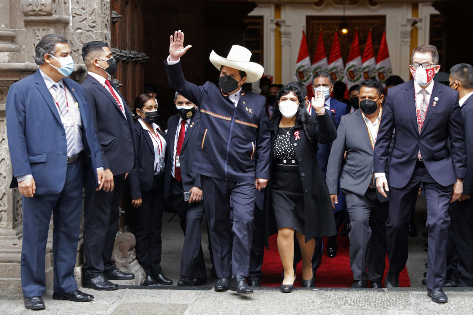 FILE - Peru's then President-elect Pedro Castillo and his wife Lilia Paredes, wave as they leave the Foreign Ministry to go to Congress for his swearing-in ceremony on his Inauguration Day in Lima, Peru, Wednesday, July 28, 2021. Castillo was often mocked for wearing a traditional hat, ridiculed for his accent and criticized for incorporating Indigenous ceremonies into official events. (AP Photo/Guadalupe Pardo, File)