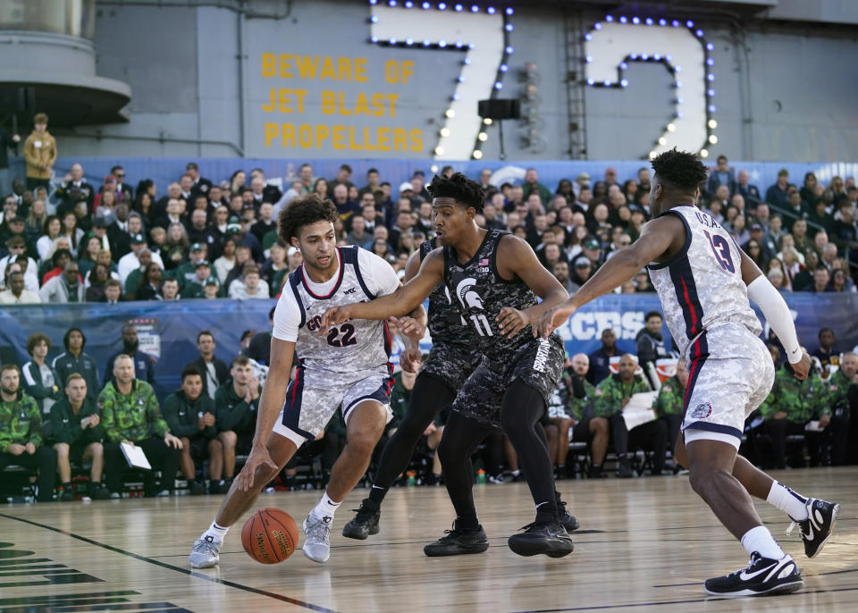 Gonzaga forward Anton Watson (22) controls the ball against Michigan State guard A.J. Hoggard (11) during the first half of the Carrier Classic NCAA college basketball game aboard the USS Abraham Lincoln in Coronado, Calif. Friday, Nov. 11, 2022. (AP Photo/Ashley Landis)