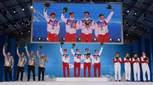 Silver medalists the United States, gold medalists Russia and bronze medalists China celebrate on the podium during the medal ceremony for the Men's 5000m Relay