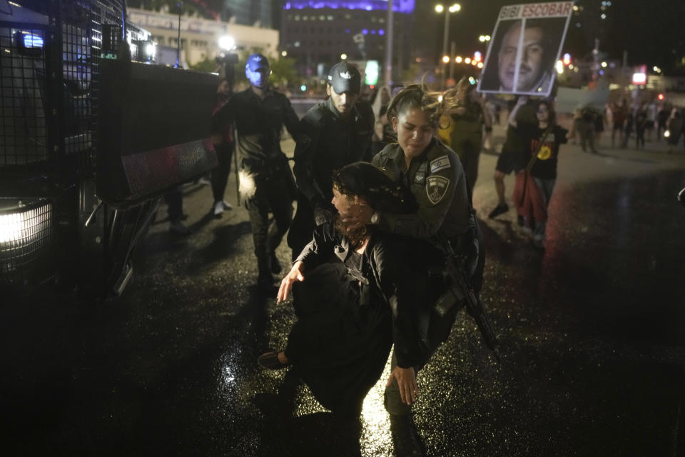 Police try to disperse demonstrators blocking a road during a protest against Israeli Prime Minister Benjamin Netanyahu's government, and calling for the release of hostages held in the Gaza Strip by the Hamas militant group, in Tel Aviv, Israel, Saturday, May 18, 2024. (AP Photo/Leo Correa)