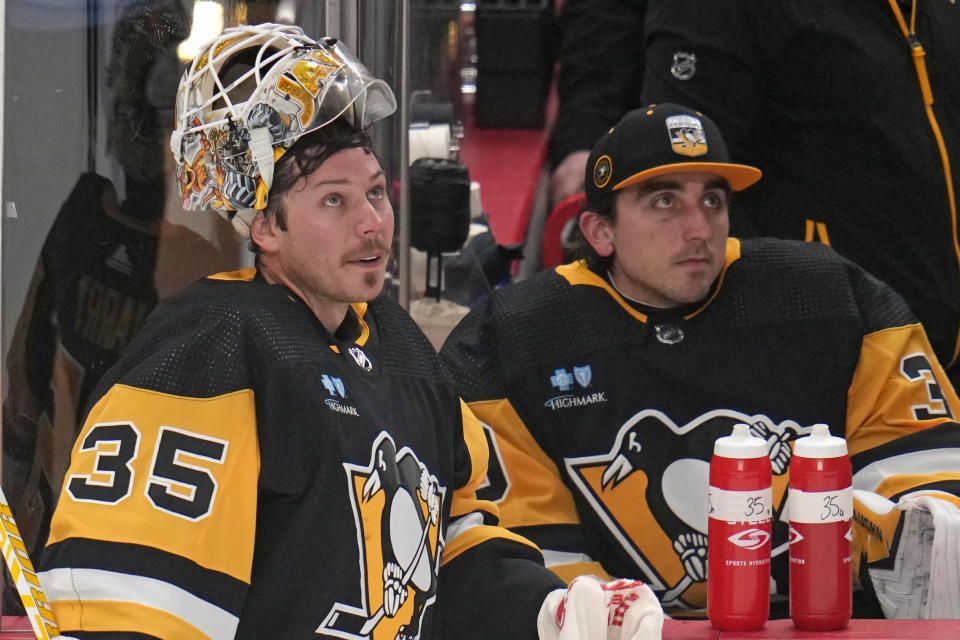 Pittsburgh Penguins goaltender Tristan Jarry (35) takes a timeout with backup Alex Nedeljkovic, right, during the first period of an NHL hockey game against the Philadelphia Flyers in Pittsburgh, Saturday, Dec. 2, 2023. (AP Photo/Gene J. Puskar)