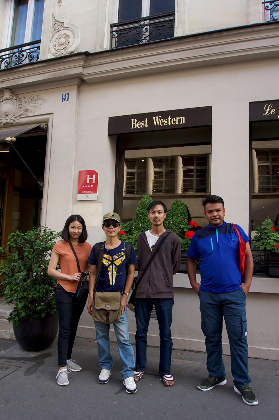 In this Monday, Aug 5, 2019 photo taken and provided by Junya Yimprasert, members of the band Faiyen, Romchalee Sombulrattanakul, Trairong Sinseubpol, Nithiwat Wannasiri, Worravut Thueakchaiyaphum pose for a group photo in Paris, France. The members of the Thai folk music group who feared for their lives because of their fiercely antiestablishment songs are celebrating being admitted to France to seek refugee status. The band fled to Thailand's neighbor Laos after a military government took power in Bangkok in 2014. Faiyen said they received constant death threats and issued urgent pleas for help to move to a safer refuge. They and their supporters said Tuesday, Aug. 6, they are now in Paris, and plan a protest at the Thai Embassy. (Junya Yimprasert via AP)