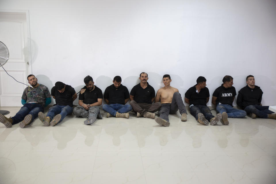 Suspects in the assassination of Haiti's President Jovenel Moise are shown to the media at the General Direction of the police in Port-au-Prince, Haiti, Thursday, July 8, 2021. Moise was assassinated in an attack on his private residence early Wednesday. (AP Photo/Joseph Odelyn)